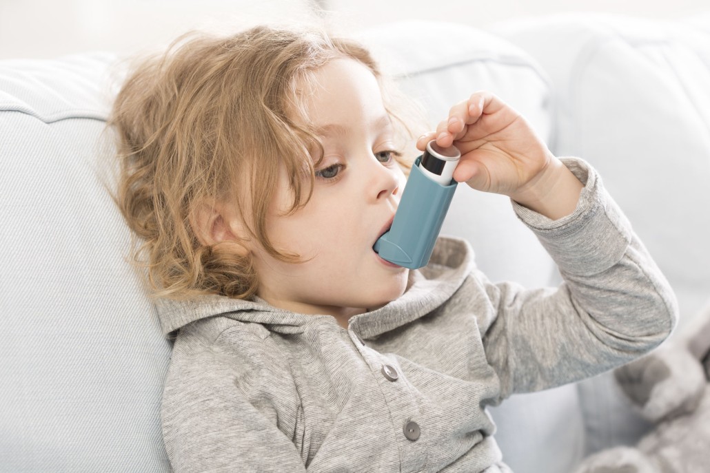 An image of a young boy using an inhaler